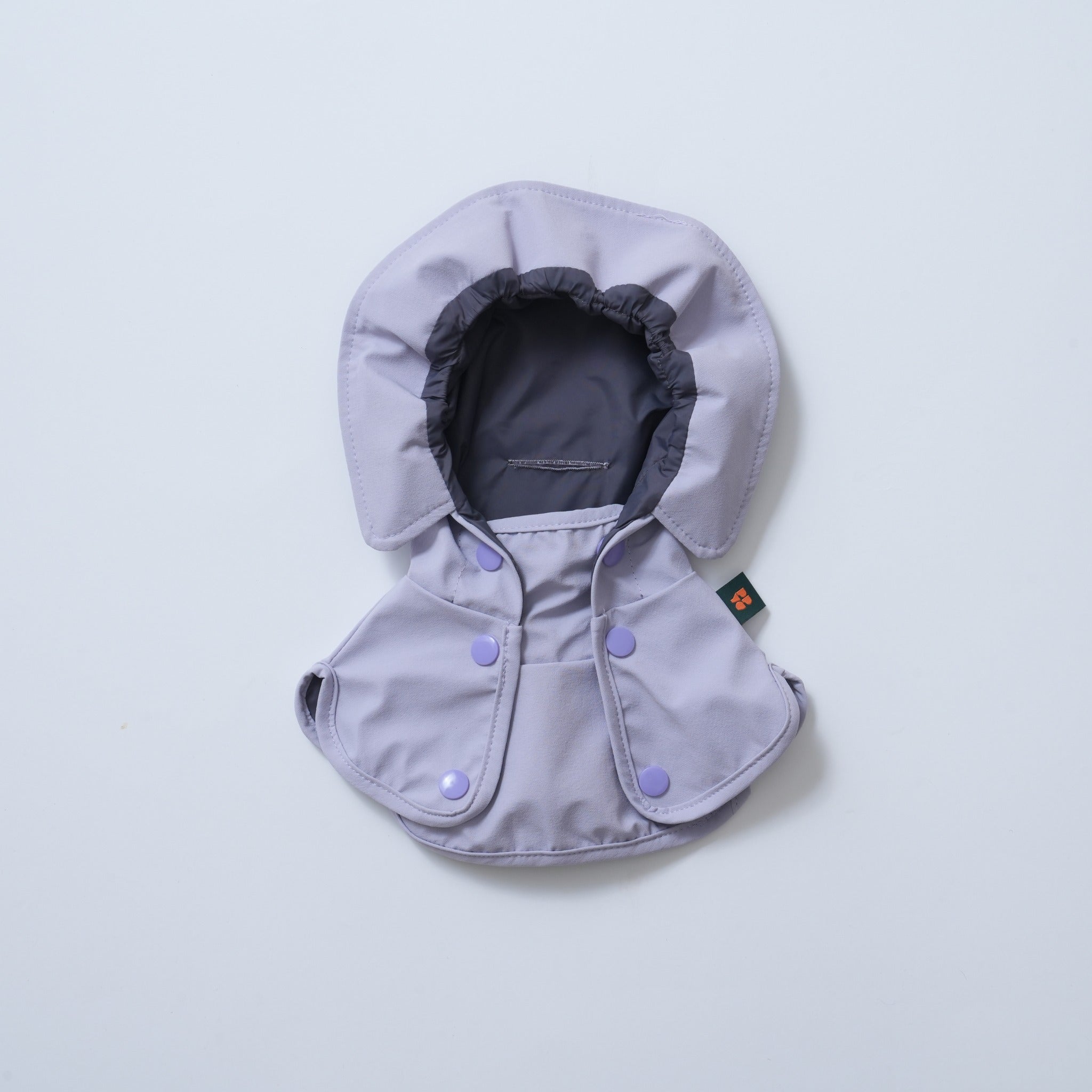 Front flat lay view of the standalone lavender Puppy Gallery GO Pro Weather Snood, showcasing the dark grey elastic face lining and the secure double snap-button front collar closure.