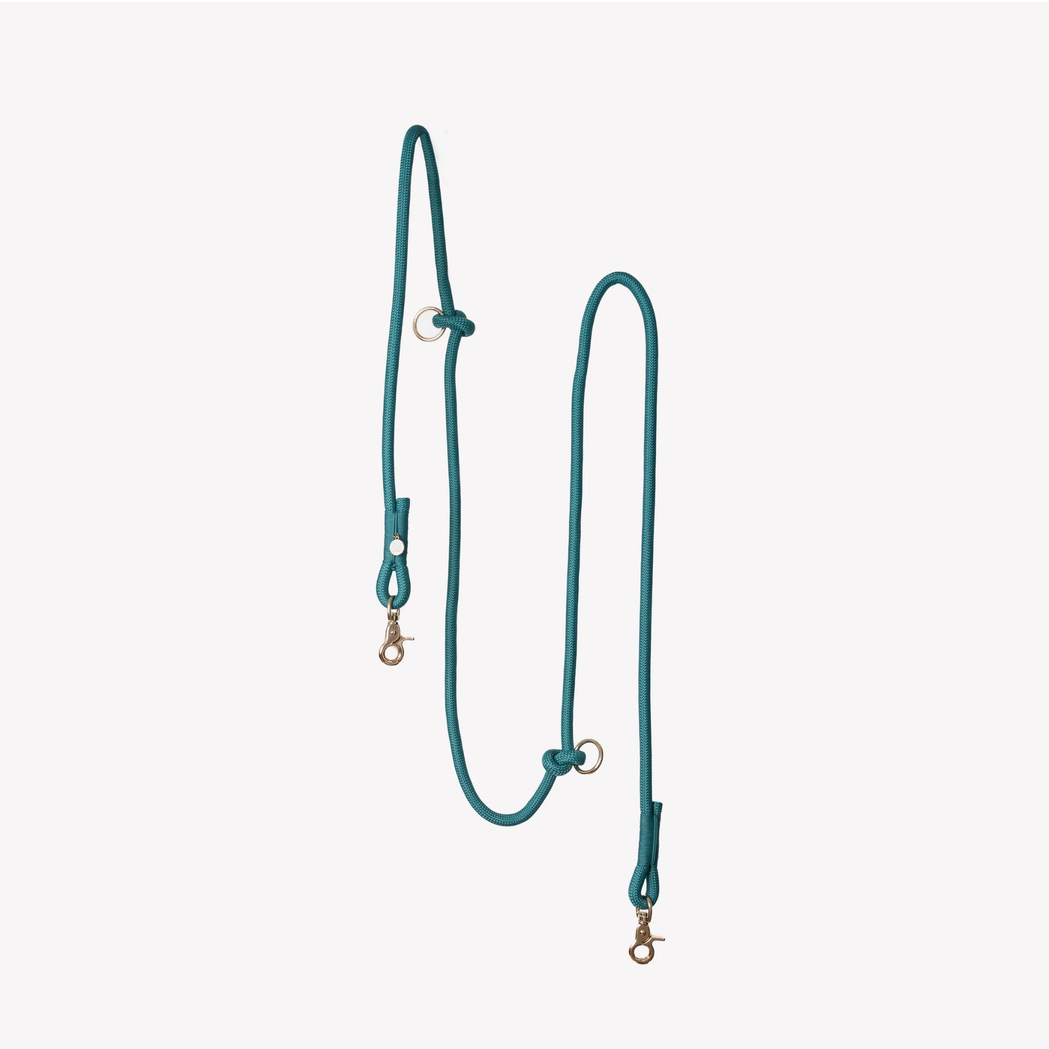 A vertical studio shot of the blue colored Furlou braided hands-free dog leash, highlighting its adjustable gold-toned rings and durable construction against a neutral background.