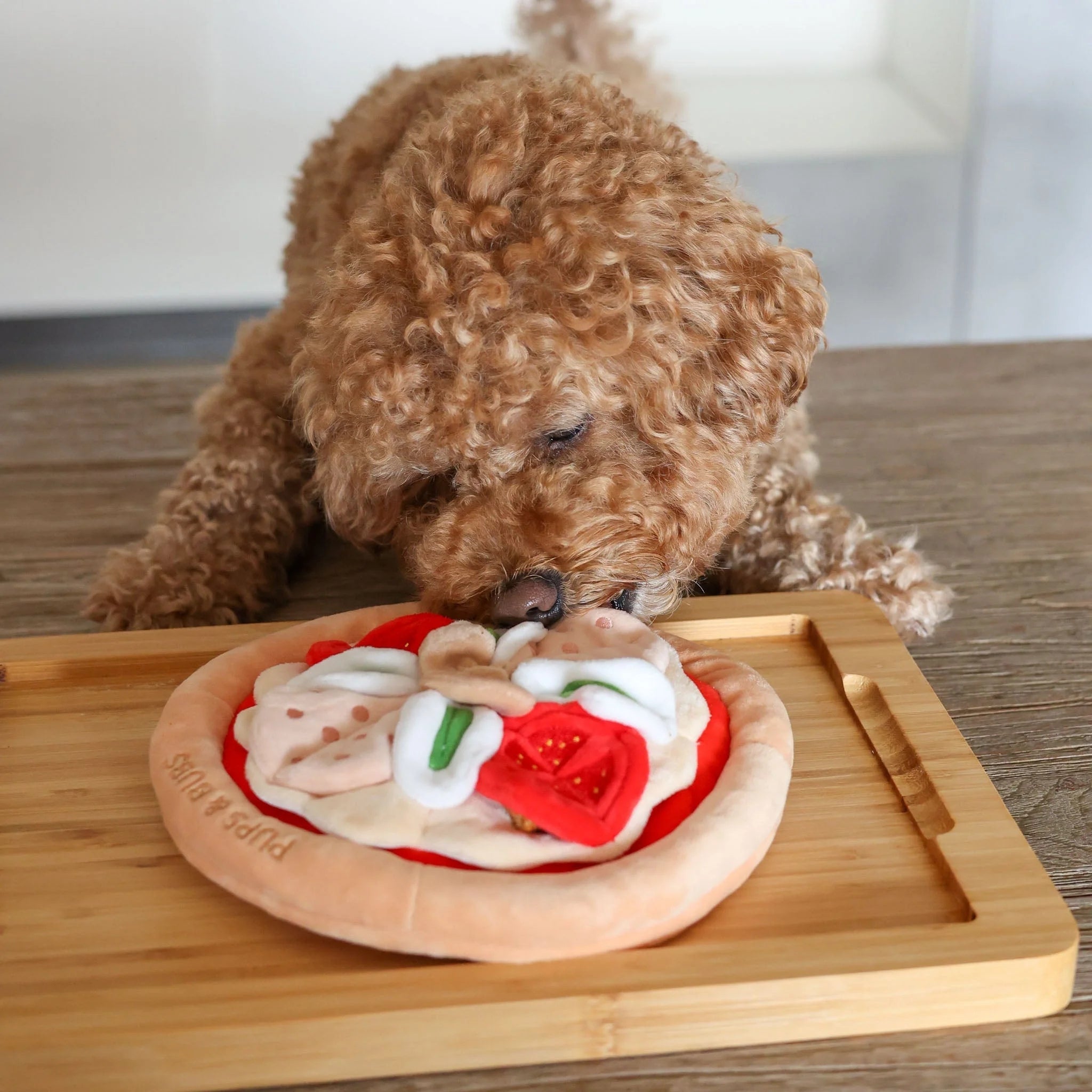 Overhead product view of the round pepperoni pizza snuffle mat by pups & bubs, a high-quality plush dog foraging mat featuring interactive fabric toppings.