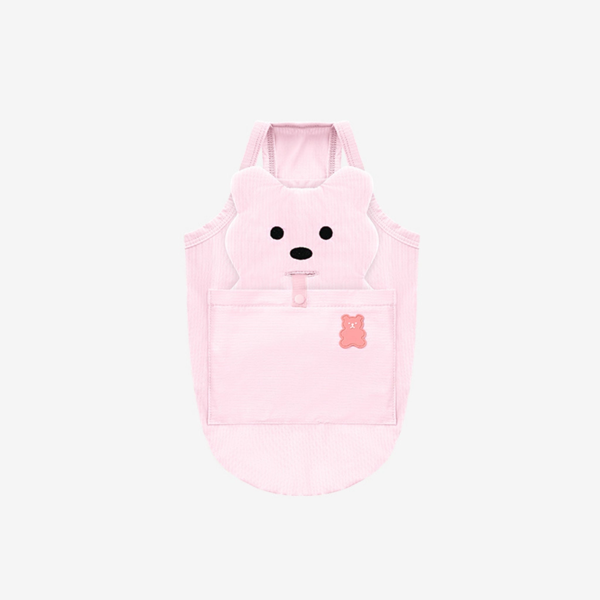 A flatlay view of the baby pink Big Bear Cooling Dog Tank Top by Puppy Gallery, showcasing the integrated plush bear head design, a back snap-button pocket with a small pink bear icon, and lightweight cooling mesh.